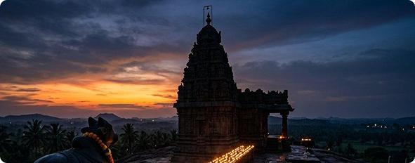 Ancient carved stone temple tower silhouette at sunset in Sri Lanka